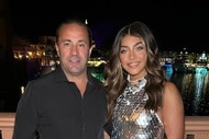 Joe Giudice and Gia Giudice smiling next to each other in front of a harbor.
