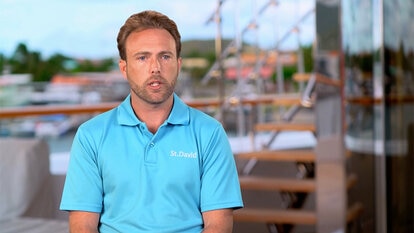 Jared Woodin talking in his uniform in front of a view of the St. David yacht,