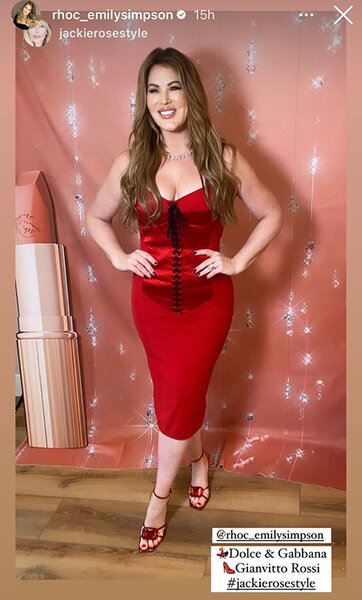 Emily Simpson in a red corset dress at an event