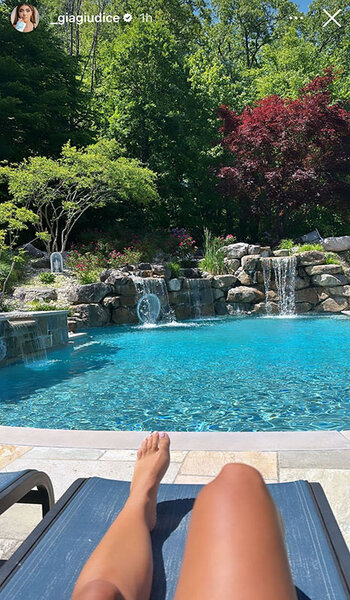 Gia Giudice laying by her family's pool.