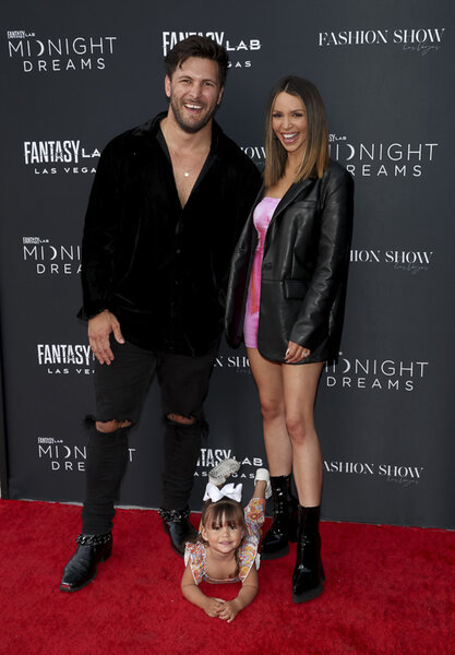 Scheana Shay, Brock Davies, and Summer Moon together on a red carpet step and repeat.