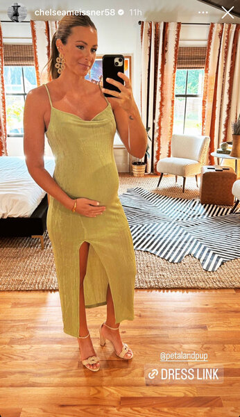 Chelsea Meisner taking a selfie in a green dress.