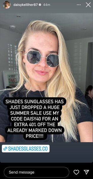 A selfie of Daisy Kelliher wearing a black top and sunglasses.