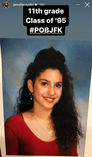 Jennifer wearing a red shirt in a curly updo and smiling as a teenager.