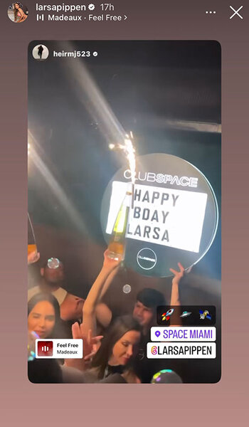 A sign wishing Larsa a happy birthday and a lit sparkler in the crowd of a club.