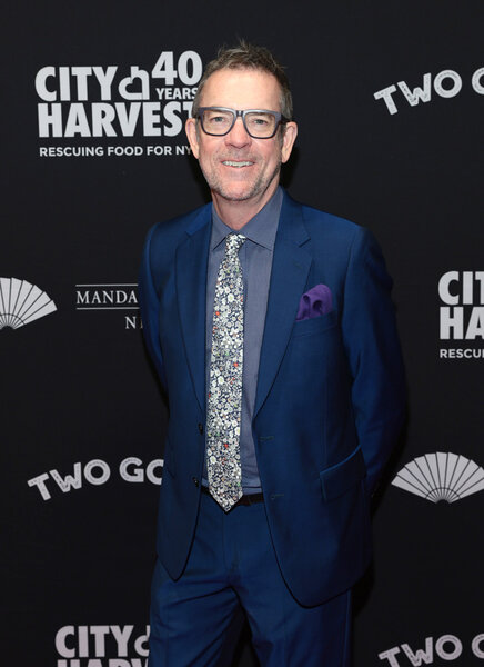 Ted Allen poses for a photo on a red carpet.