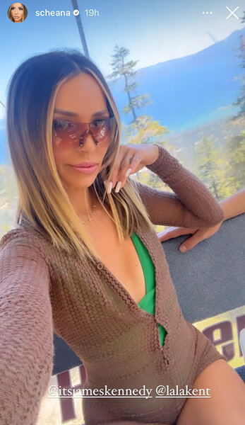 Scheana wearing a green one-piece swimsuit with a coverup and sunglasses on a boar.