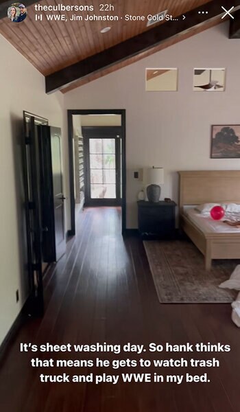 Briana's bedroom with a wooden ceiling and floors and white walls.