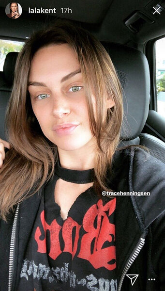 Lala with brown hair wearing a hoodie in a car.