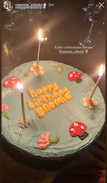 Naomie's blue mushroom and floral themed birthday cake with candles.