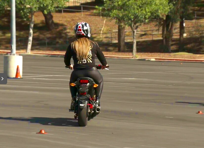 Emily Simpson rides a motorcycle while filming The Real Housewives of Orange County.
