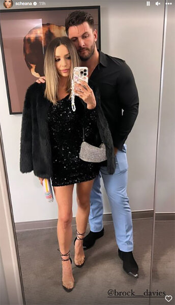 Scheana and Brock pose together in a mirror wearing black outfits.