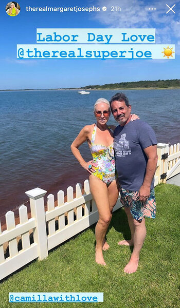 Margaret Josephs in a swimsuit smiling next to Joe Benigno standing on grass in front of a white fence and a body of water in the background.