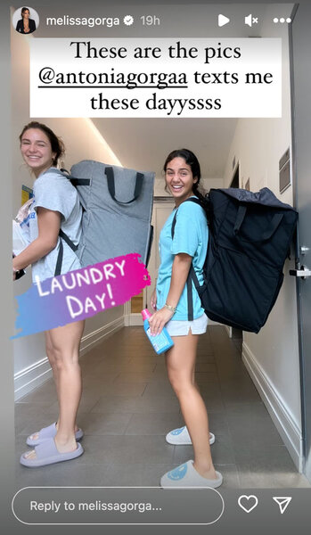 Antonia Gorga and a friend with hampers full of dirty clothes, on their way to do laundry.
