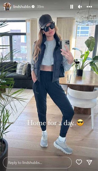 Lindsay Hubbard posing for a mirror selfie in a living room. Overlaid text, "Home for a day..[Smiling Face with Sunglasses emoji]"
