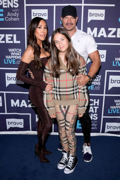 Angie Katsanevas and her husband Shawn Trujillo and their daughter, Elektra Trujillo, in front of the WWHL step and repeat.