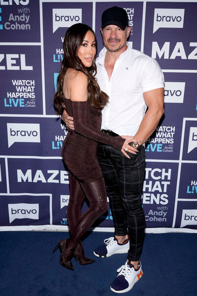 Angie Katsanevas and her husband Shawn Trujillo in front of the WWHL step and repeat.