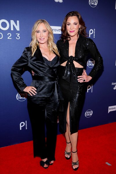 Sonja Morgan and LuAnn de Lesseps posing together while walking the red carpet for BravoCon 2023.