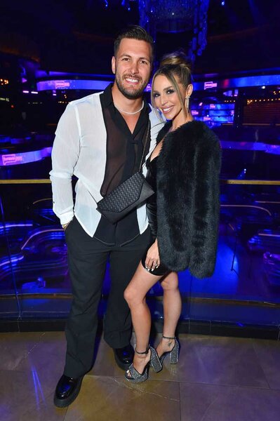 Brock Davies and Scheana Shay posing and smiling together during BravoCon 2023.