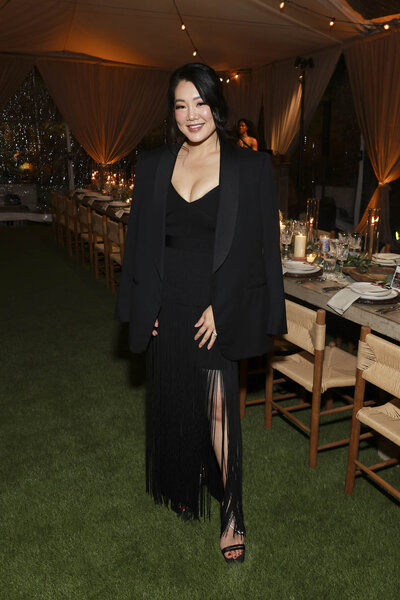 Crystal Kung Minkoff smiling and posing in an all black outfit.