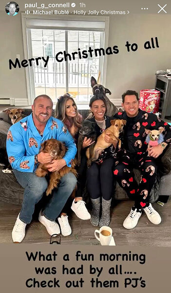 Dolores Catania with Paul Connell, Frank Catania, and Brittany Mattessich wearing holiday pajamas and holding their pets.
