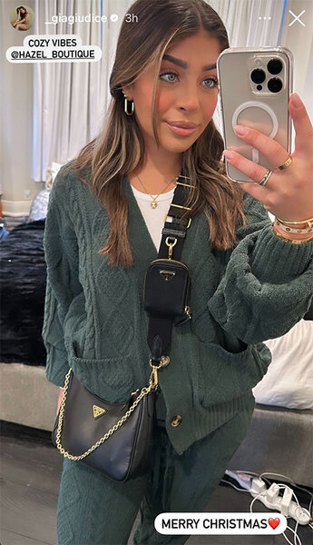 Gia Giudice takes a mirror picture of her green Christmas outfit.