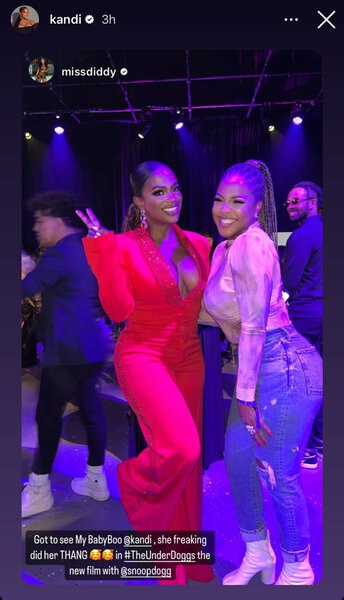 Kandi Burruss wears a plunging v neck red romper while at a party with her friend.