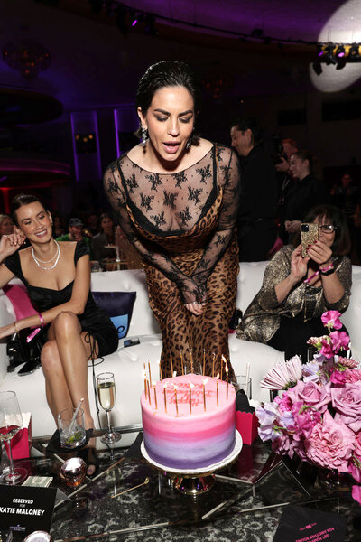 Katie Maloney blowing out candles at the Vanderpump Rules Season 11 premiere party.