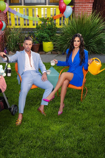 Michelle Lally wearing a blue dress and Jesse Lally wearing a light blue suit on a yard with balloons around them