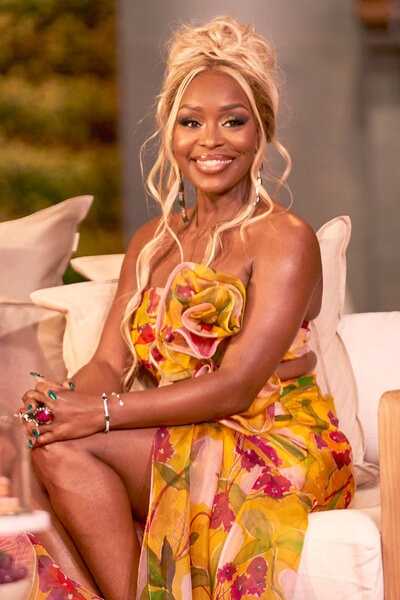 Quad Webb wearing a strapless yellow floral gown at the Married to Medicine Season 10 reunion.