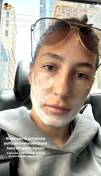 Amanda Batula with a face mask on in a taxi cab
