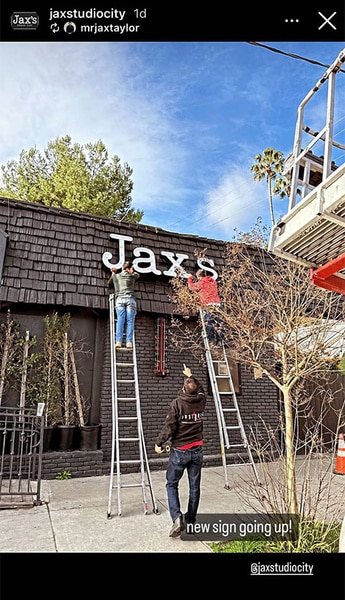A 'Jax's Bar' sign being put up on the exterior of the bar