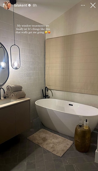Lala Kent's new bathroom with a floating tub and a vanity.