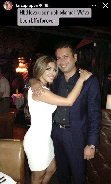 Larsa Pippen wearing a white dress and hugging her friend.