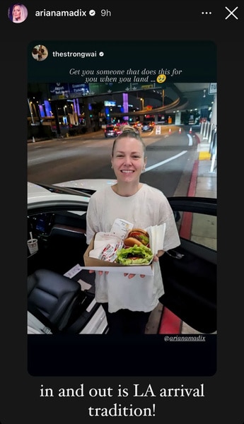 Ariana Madix standing outside of her car with an order of In and Out Burger