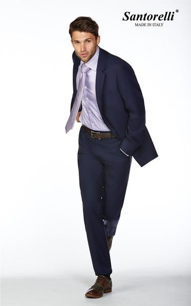 Tom Schwartz modeling a blue suit with his hands in his pocket
