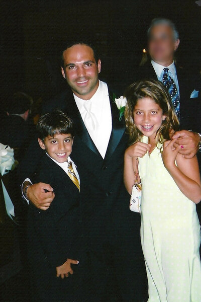 Young Joe Gorga with his family wearing a suit.