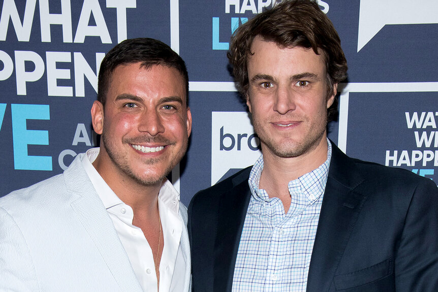 Jax Taylor and Shep Rose standing in front of the Watch What Happens Live step and repeat.