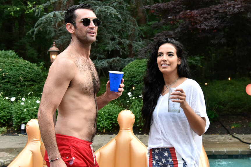 Danielle Olivera and Carl Radke stand next to each other at a Fourth of July party.