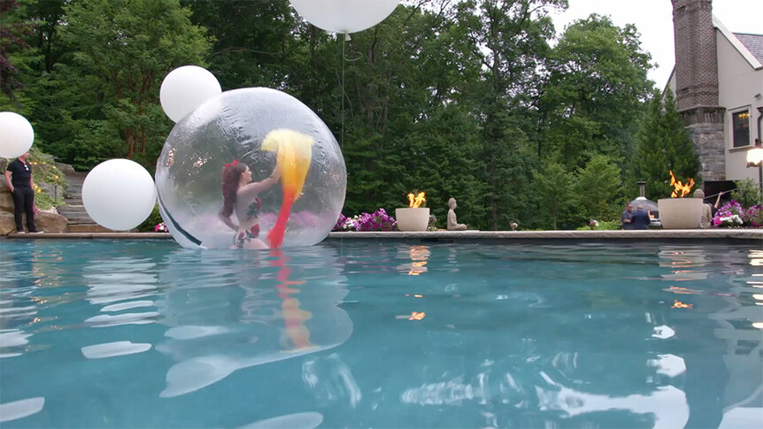 Dancer inside of a bubble floating on a pool at Teresa Giudice's housewarming party.