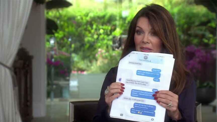 Lisa Vanderpump holding up a printed out text thread.
