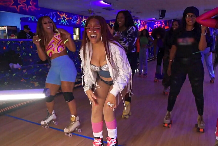 Drew Sidora filming her music video at the roller rink.