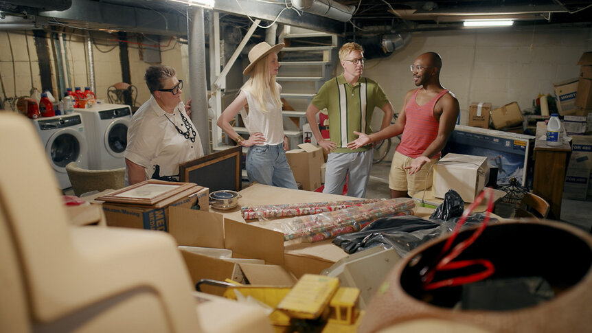 Ella, Katarina, Johan and Godfrey talk together in a cluttered basement.