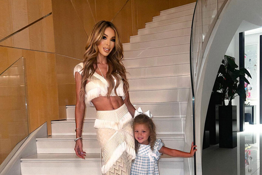Lisa Hochstein and Elle posing together on a staircase.