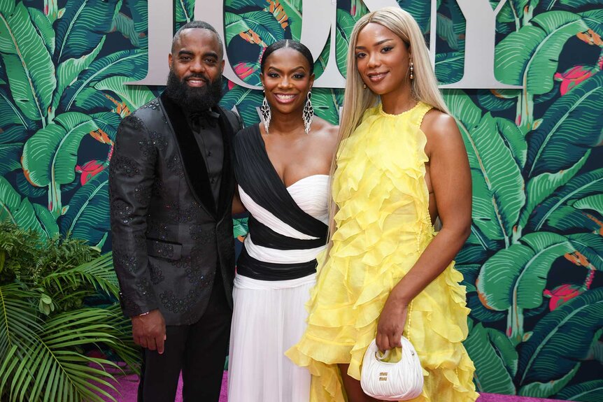 Kandi Burruss poses on the red carpet for the 76th Tony Awards with husband Todd Tucker and daughter Riley Burruss