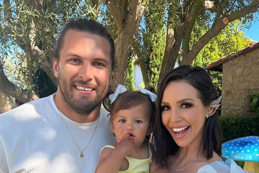 Scheana Shay, Brock Davies, and Summer Moon together at an outdoor party.