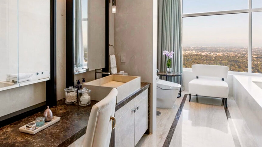 A neutral-toned bathroom with a large window.