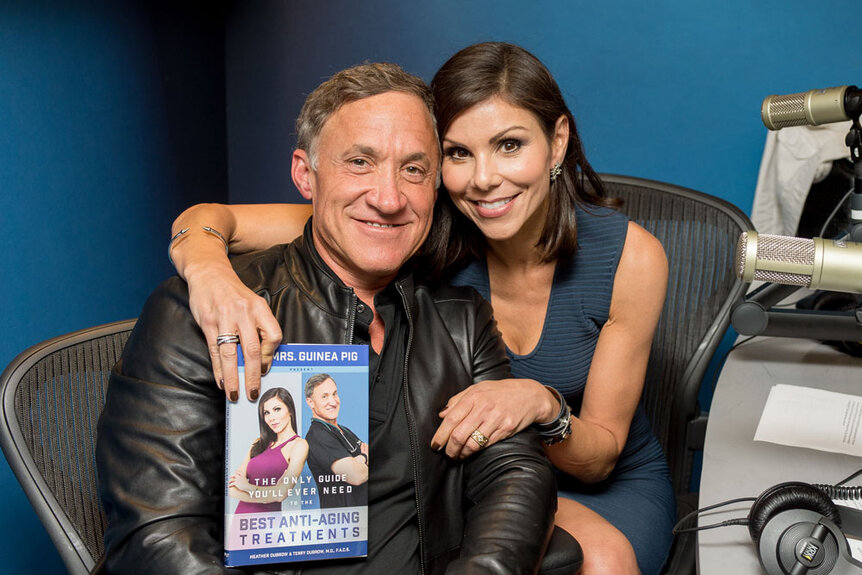 Heather Dubrow and Terry Dubrow posing with their book at Sirius Radio