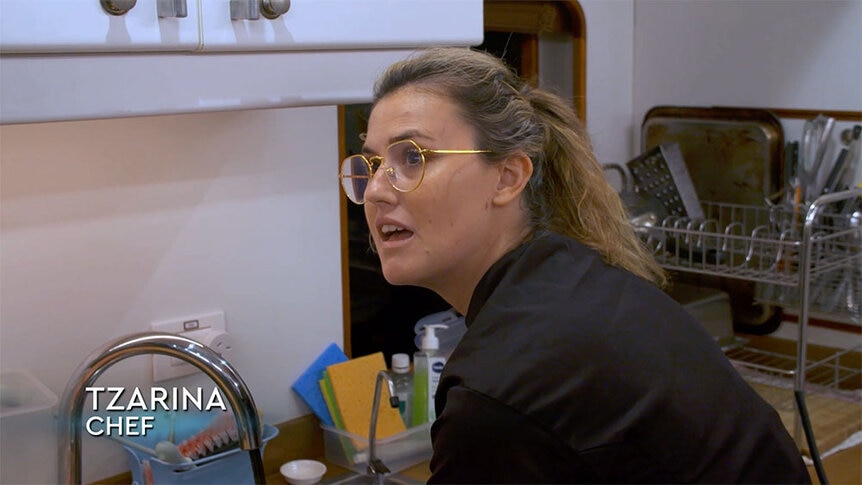 Tzarina in the kitchen talking to Jason.