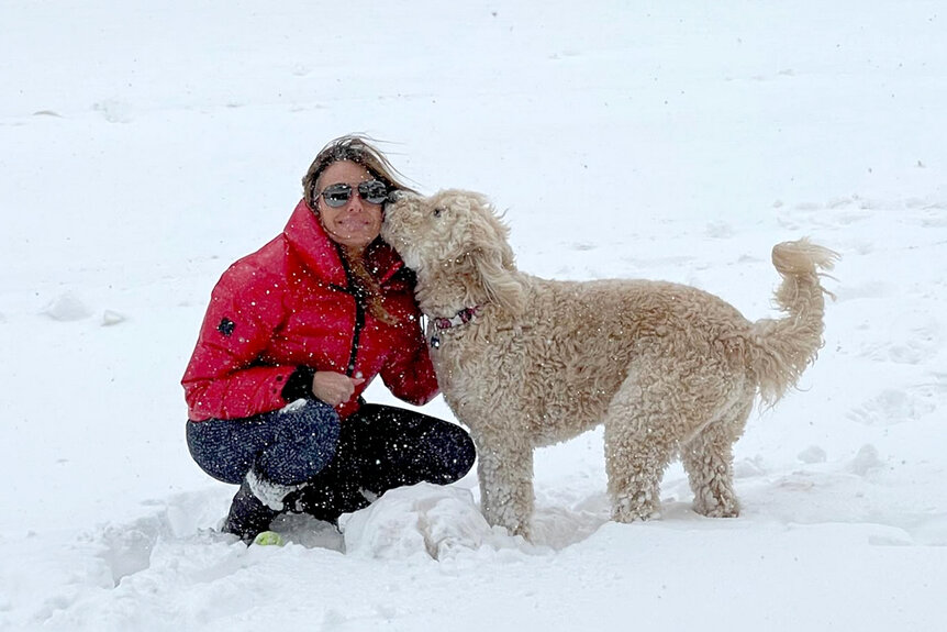 Captain Sandy Yawn’s girlfriend, Leah Shafer, outside in the snow with her dog, Bailey.
